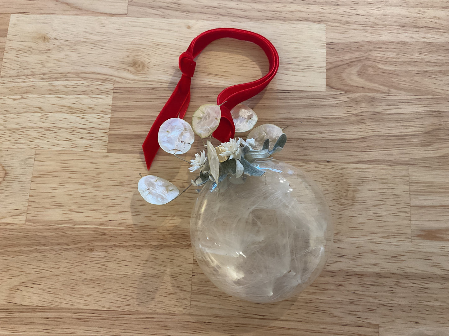 Glass ornament with milkweed