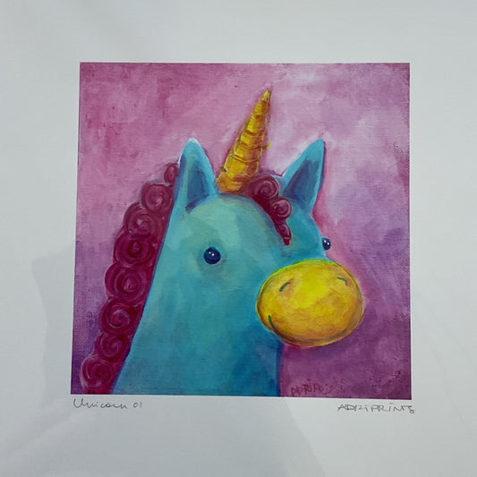 Colorful unicorn painting in a white frame on a wooden surface