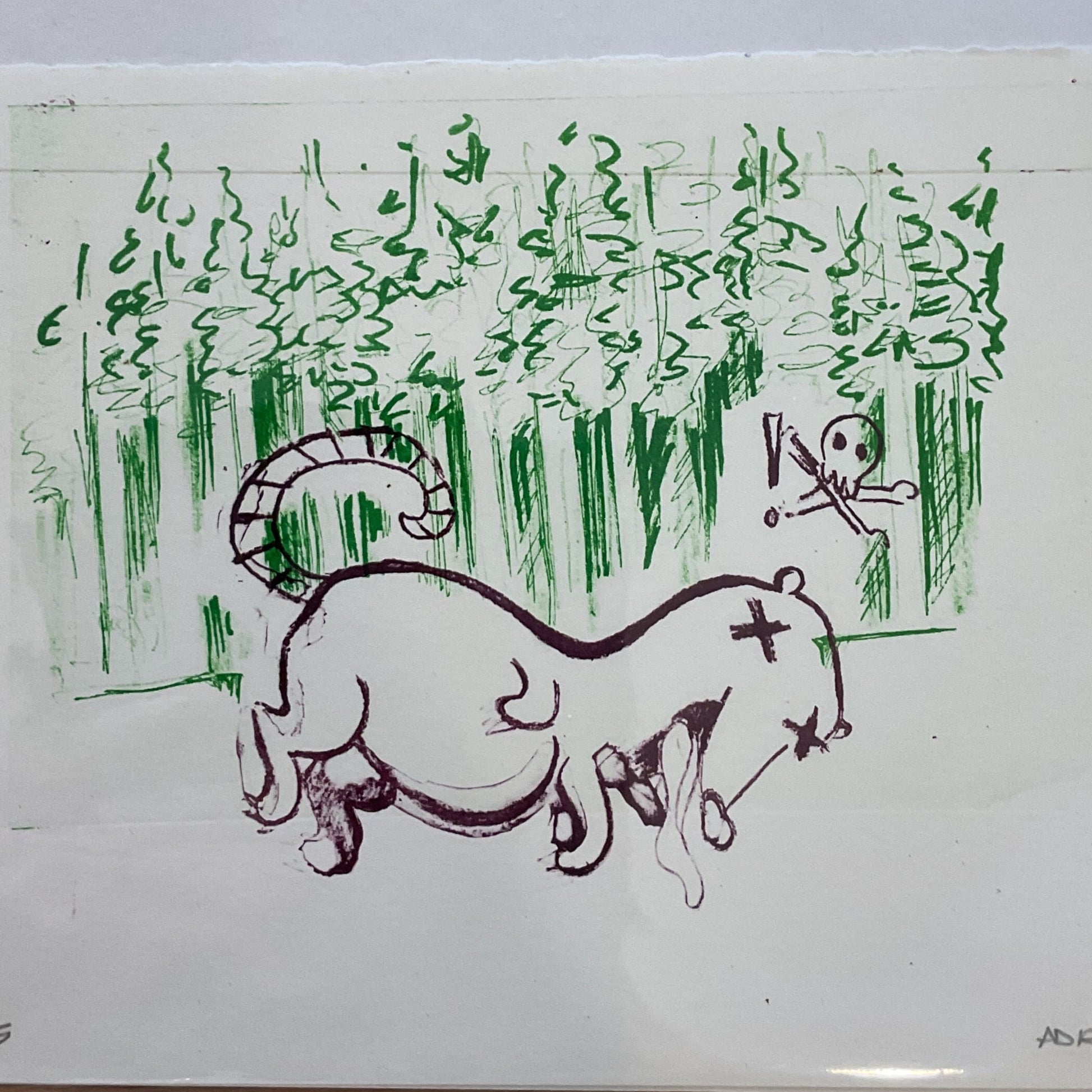 Hand-drawn illustration of a cat and bird on a piece of paper, placed on a wooden surface.