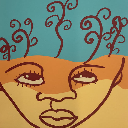 Abstract artwork with stylized face and swirling lines on a wooden surface