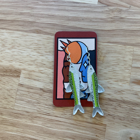 Card with a colorful illustration of a character holding two fish on a wooden surface