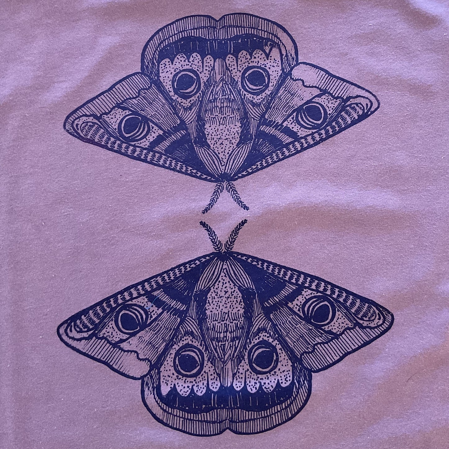 T-shirt with a graphic of two butterflies on a light background