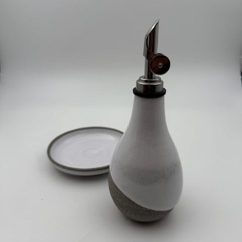 Wall-mounted lamp with a concrete base and metal fixture on a white wall.