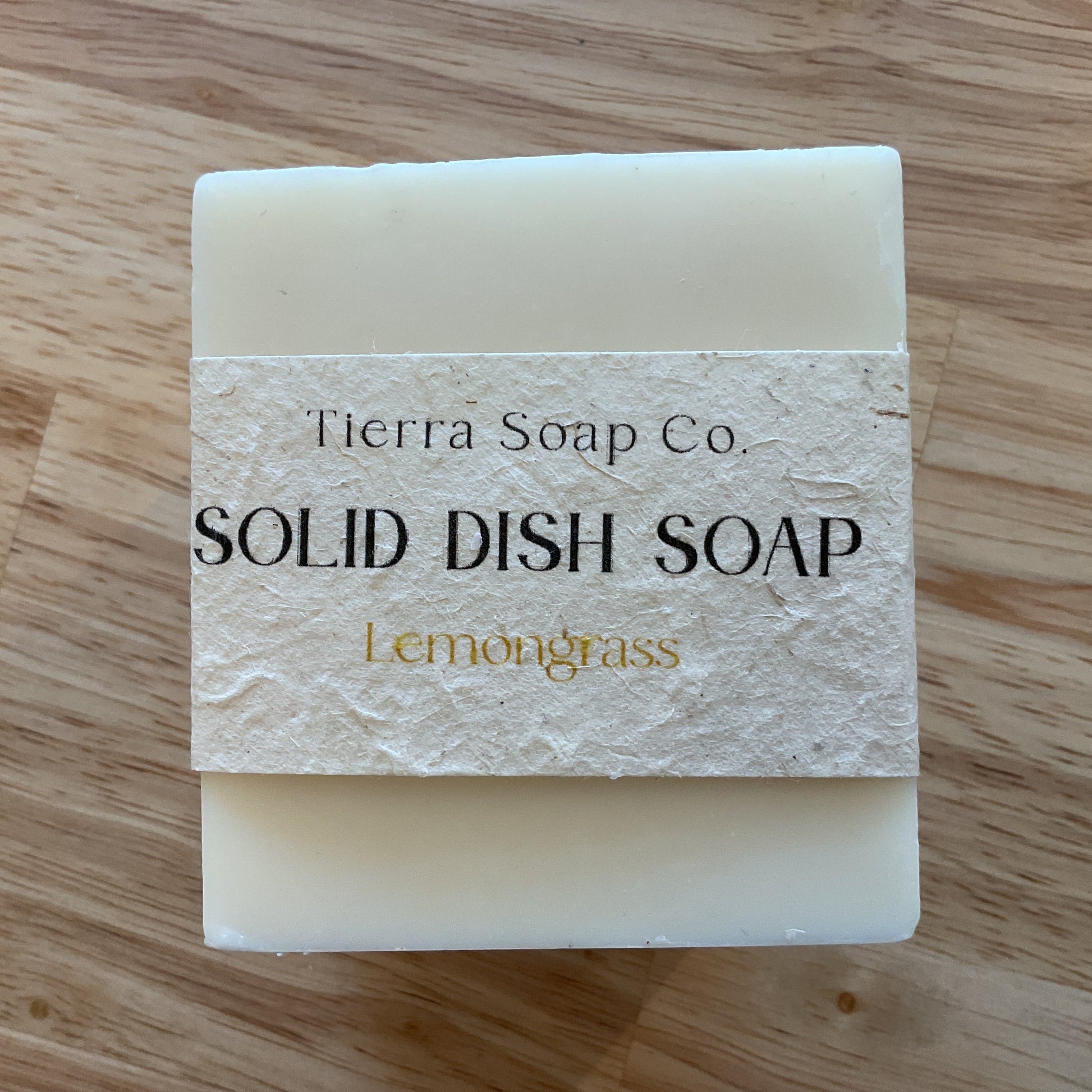 Solid dish soap bar from Tierra Soap Co. on a wooden surface